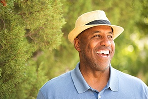 man smiling in the forest