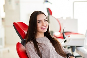 young woman smiling in dental chair