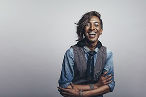 person smiling and crossing their arms
