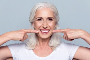 Woman pointing to her beautiful smile