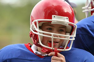 Preteen boy placing mouthguard