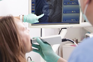 Dentist and patient looking at intraoral photos