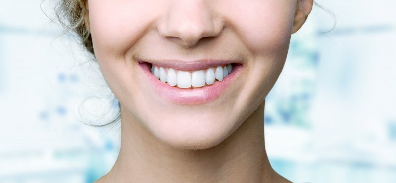 Woman smiling after fluoride treatment