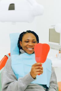 Woman holding dental mirror at dentist