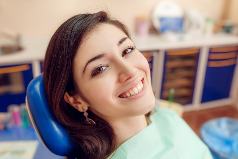 person smiling at their cosmetic dentist’s office