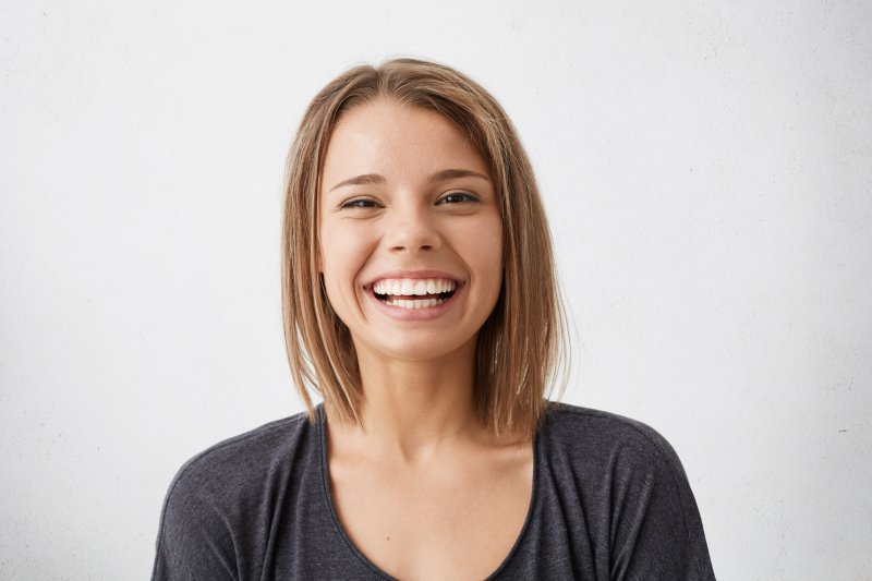 person smiling after having gray teeth fixed